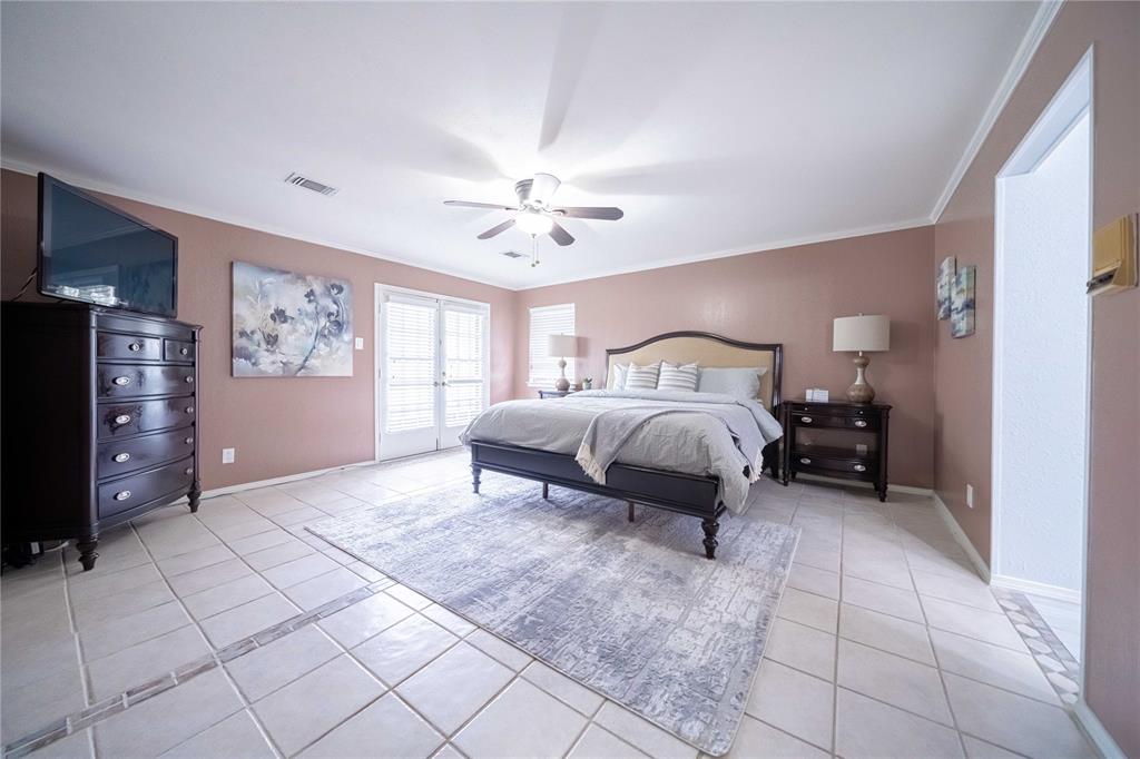919 Green Hills Road Duncanville, TX 75137 - Photo 17 of 37 Bedroom with light tile patterned floors, french doors, baseboards, a ceiling fan, and ornamental molding
