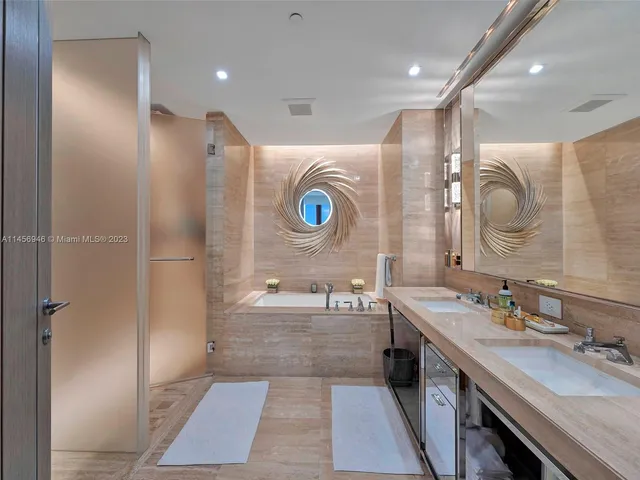 a bathroom with a double vanity sink mirror and shower