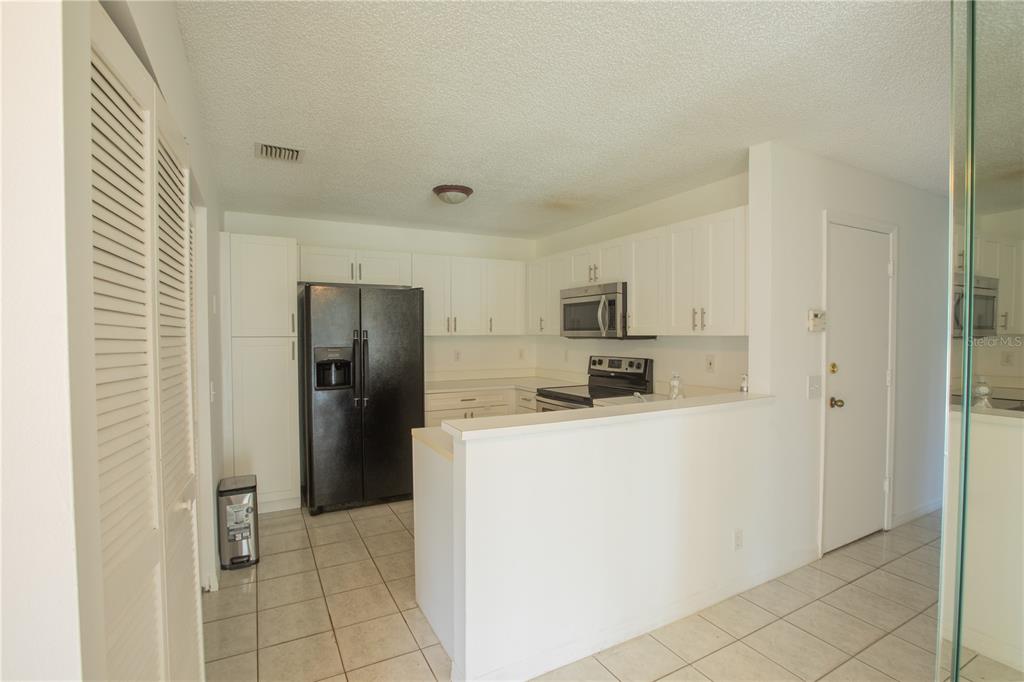 1711 Southwest 116th Way Miramar, FL 33025 - Photo 11 of 33 a kitchen with stainless steel appliances a refrigerator and a stove
