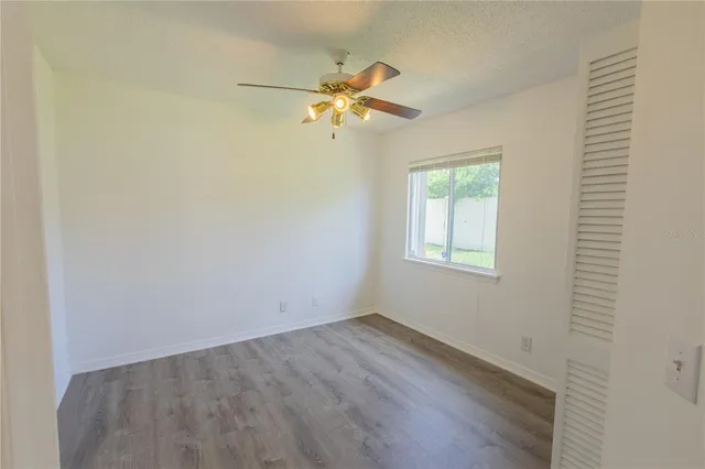 a view of a room with wooden floor and fan