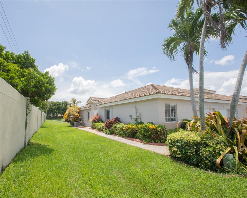 1711 Southwest 116th Way Miramar, FL 33025 - Photo 2 of 33 a front view of a house with garden