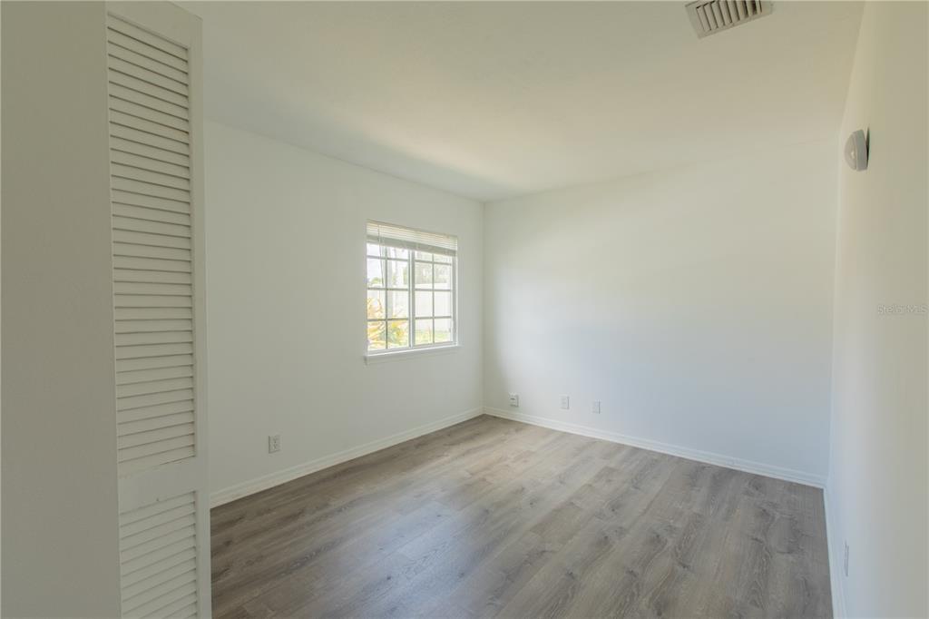 1711 Southwest 116th Way Miramar, FL 33025 - Photo 22 of 33 an empty room with wooden floor and windows