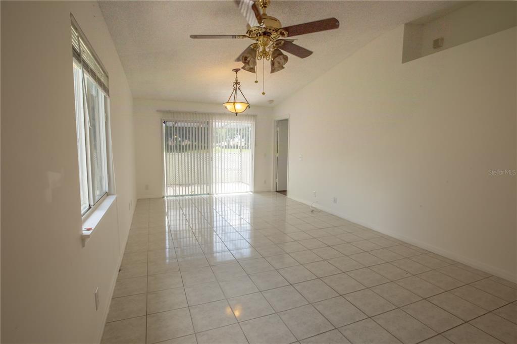 1711 Southwest 116th Way Miramar, FL 33025 - Photo 3 of 33 en empty room with windows and chandelier fan
