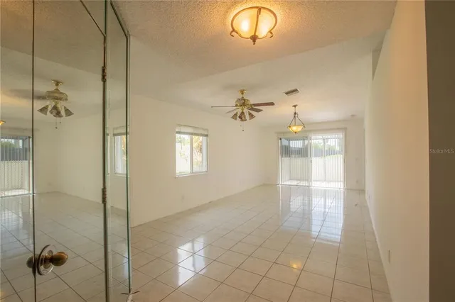 a bathroom with a glass shower door and a window
