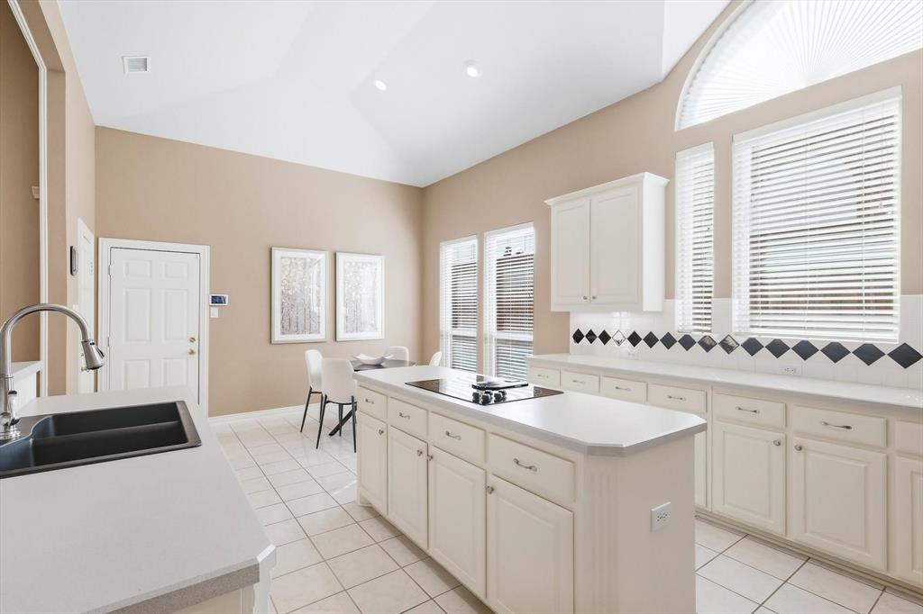 1447 Falls Road Coppell, TX 75019 - Photo 11 of 39 Spacious Island Kitchen with an Abundance of Tall Cabinetry & Prep Space