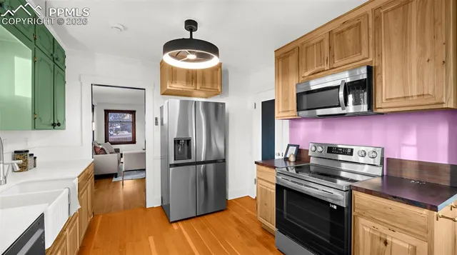 a kitchen with stainless steel appliances granite countertop a stove refrigerator and microwave