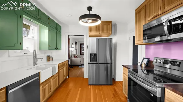 a kitchen with a refrigerator a stove and a sink