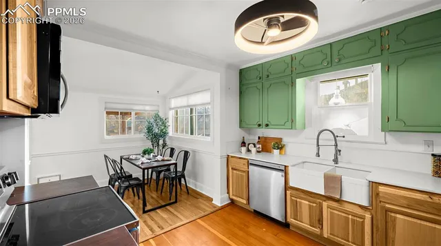 a kitchen with a sink cabinets and window