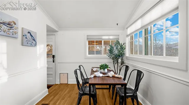 a view of a dining room with furniture and window