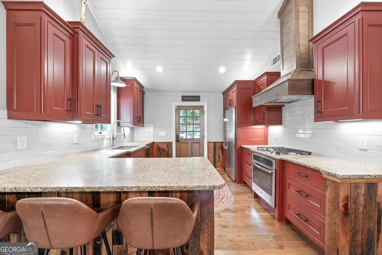170 B Tater Hill Road Jackson, GA 30233 - Photo 14 of 74 a kitchen with stainless steel appliances granite countertop a stove a sink dishwasher and cabinets with wooden floor