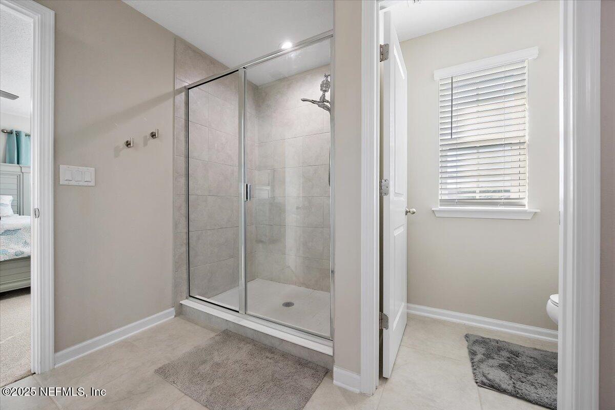 156 Clarys Run St. Augustine, FL 32092 - Photo 13 of 20 a bathroom with a shower and a glass door