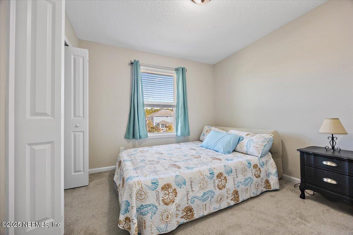156 Clarys Run St. Augustine, FL 32092 - Photo 15 of 20 a bedroom with a bed and a window