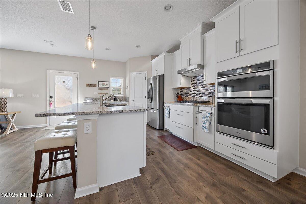 156 Clarys Run St. Augustine, FL 32092 - Photo 5 of 20 a kitchen with stainless steel appliances granite countertop a stove a sink and a refrigerator