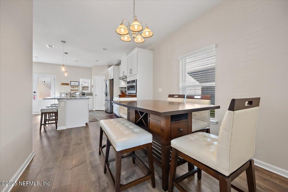 156 Clarys Run St. Augustine, FL 32092 - Photo 7 of 20 a view of a dining room with furniture and a chandelier