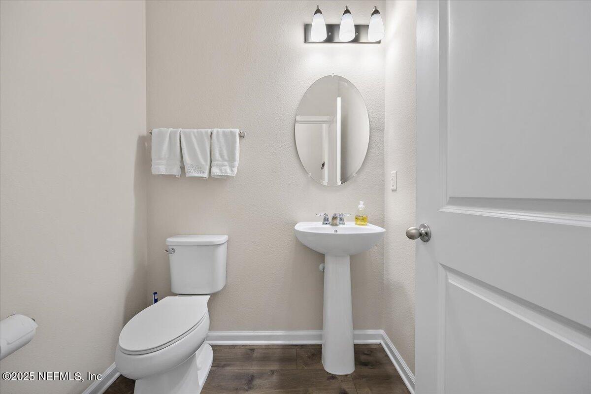 156 Clarys Run St. Augustine, FL 32092 - Photo 8 of 20 a bathroom with a toilet sink and mirror