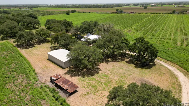 an aerial view of a house with a yard