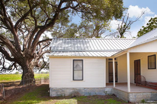 a front view of a house with a yard garage and outdoor seating