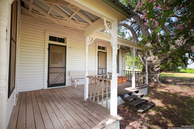 a view of a patio with table and chairs and wooden floor