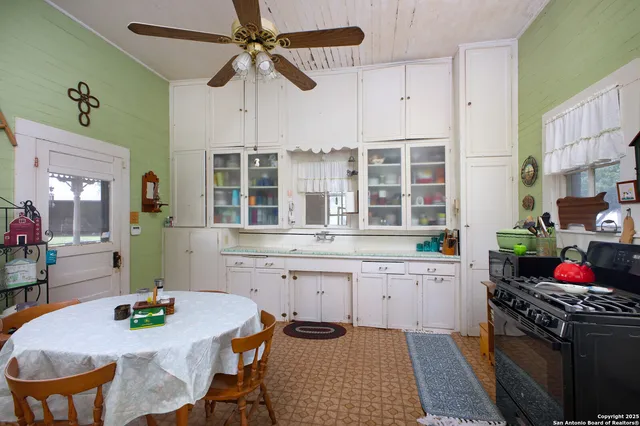 a dining room with furniture a chandelier and wooden floor