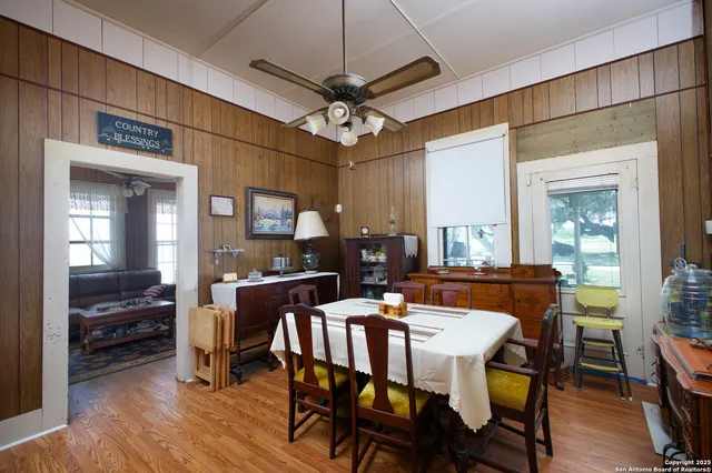 a living room with furniture a flat screen tv and a window