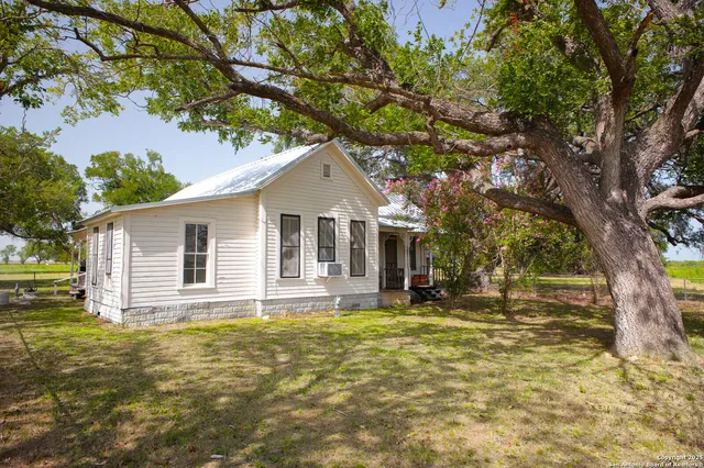 a house that has a tree in front of the house
