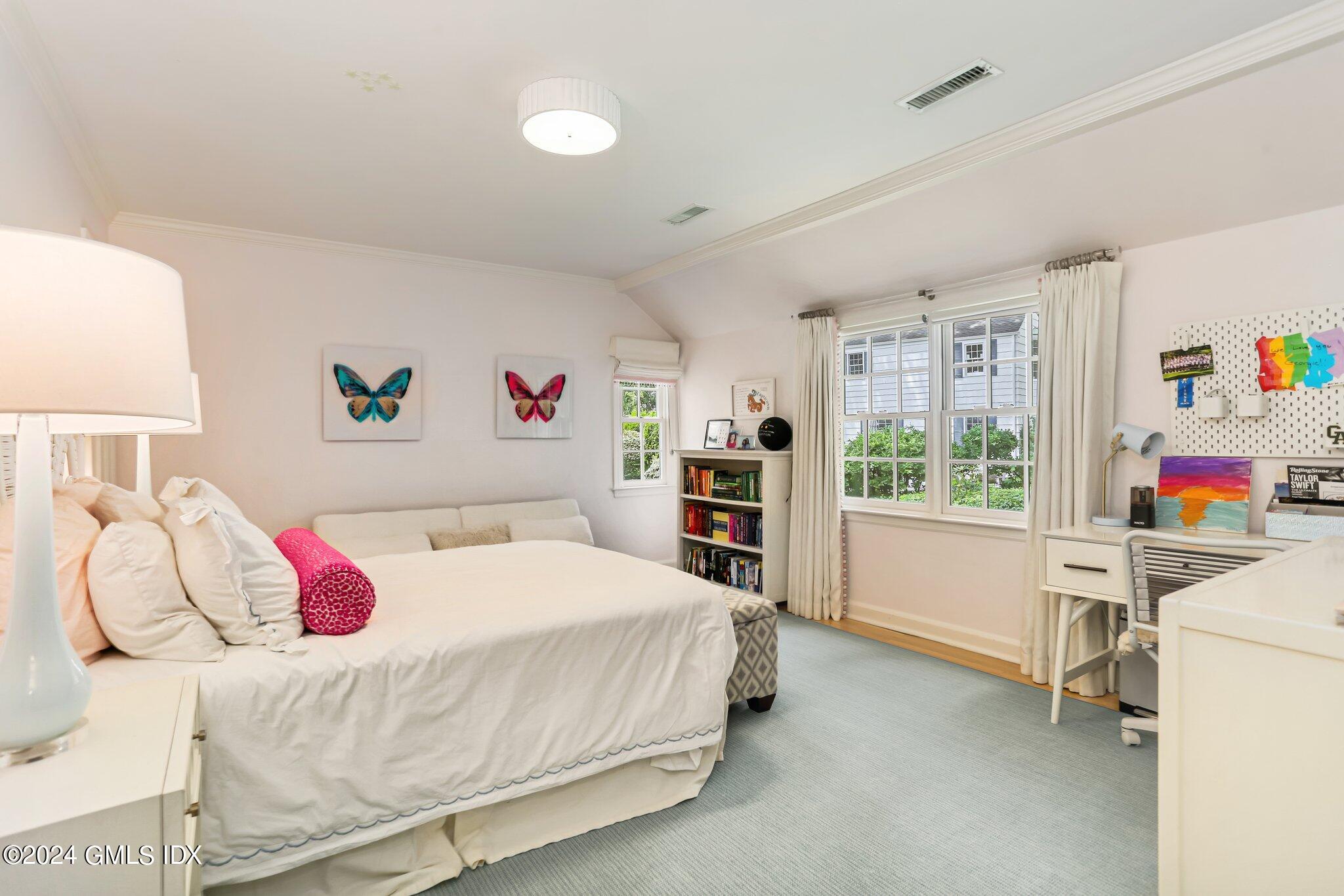 7 Wesskum Wood Road Riverside, CT 06878 - Photo 13 of 29 a bedroom with a bed a desk and a book shelf