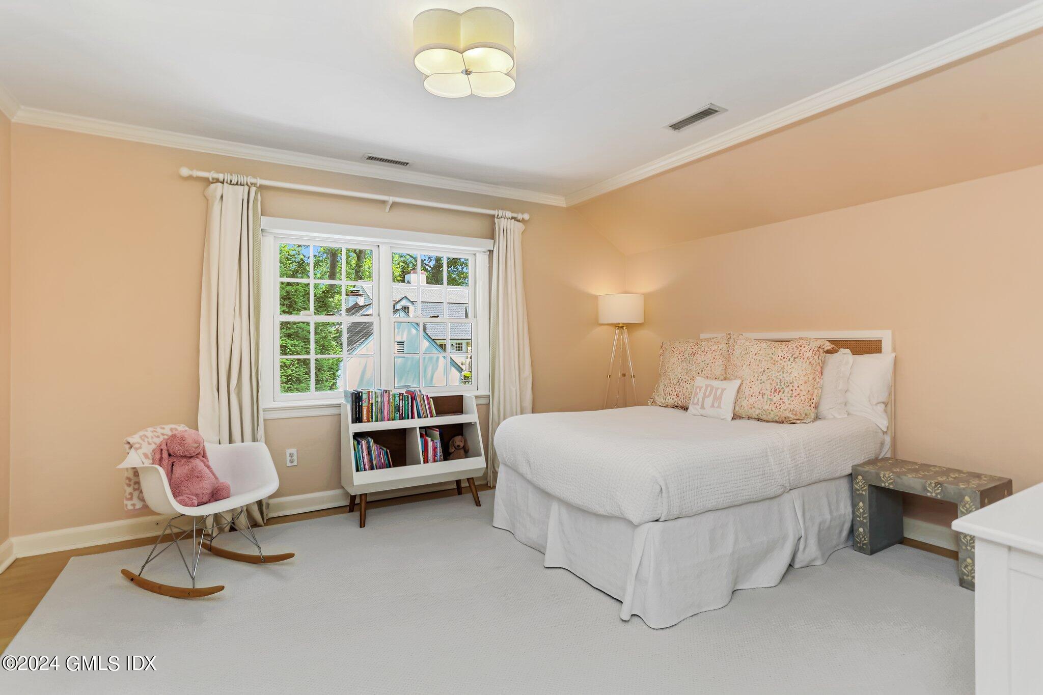 7 Wesskum Wood Road Riverside, CT 06878 - Photo 18 of 29 a bedroom with a bed and a chandelier