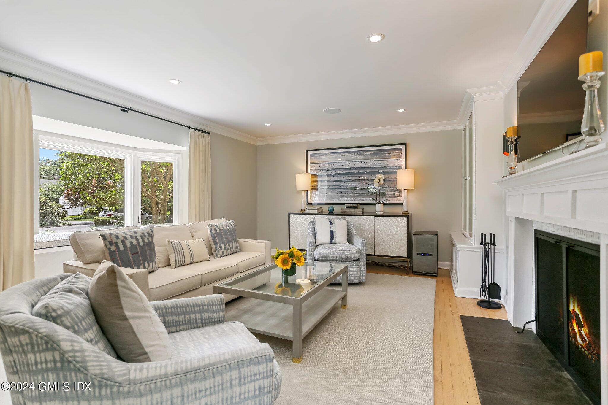 7 Wesskum Wood Road Riverside, CT 06878 - Photo 3 of 29 a living room with furniture or fireplace and a flat screen tv