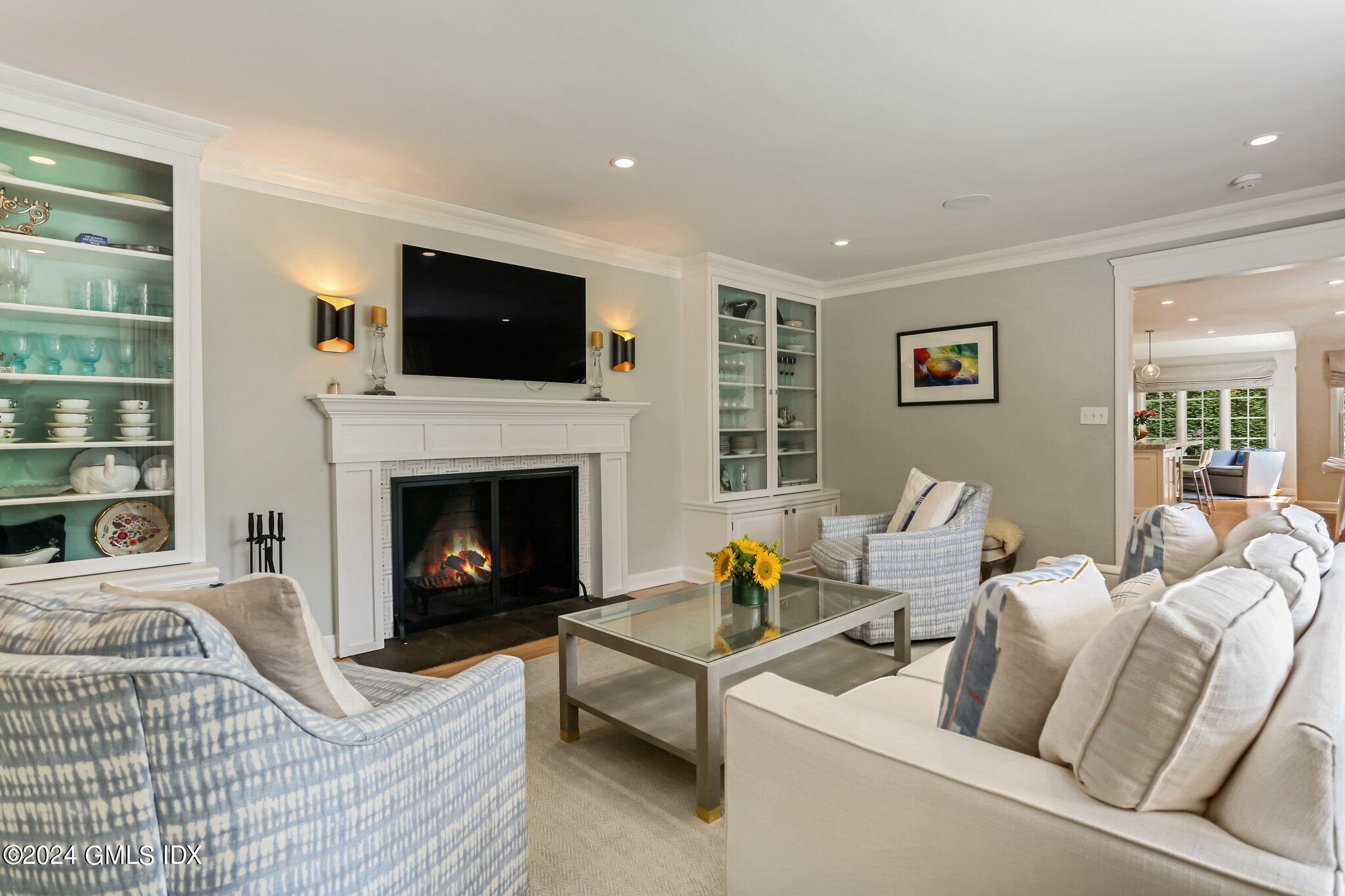 7 Wesskum Wood Road Riverside, CT 06878 - Photo 4 of 29 a living room with furniture a flat screen tv and a fireplace