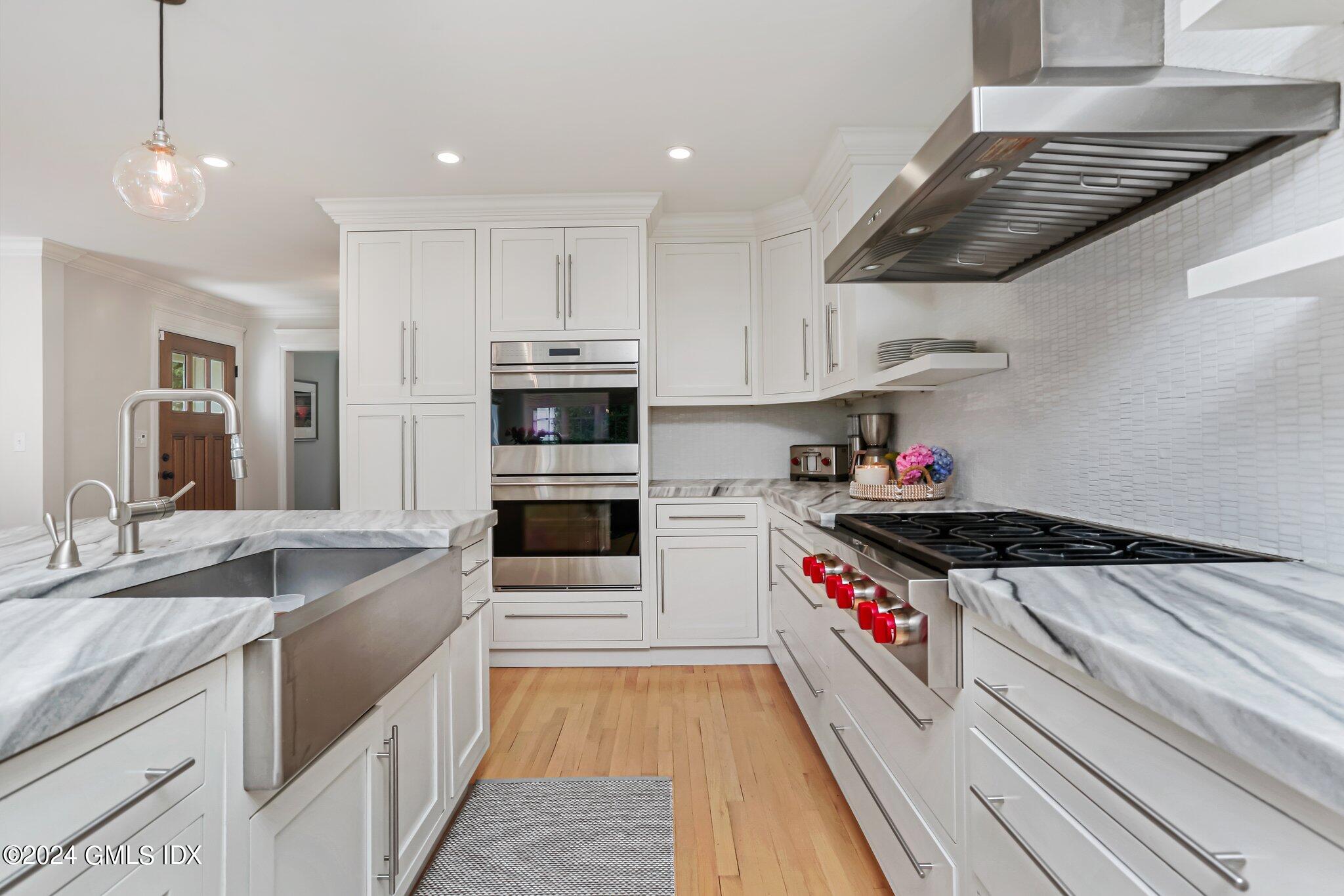 7 Wesskum Wood Road Riverside, CT 06878 - Photo 7 of 29 a kitchen with stainless steel appliances granite countertop a sink stove and cabinets