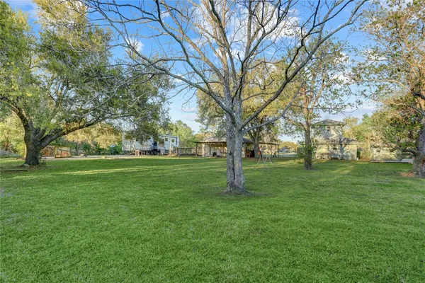 a huge green field with lots of trees