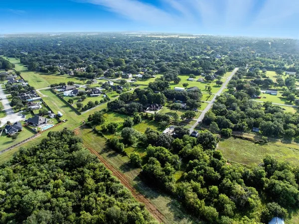 an aerial view of residential houses with city view