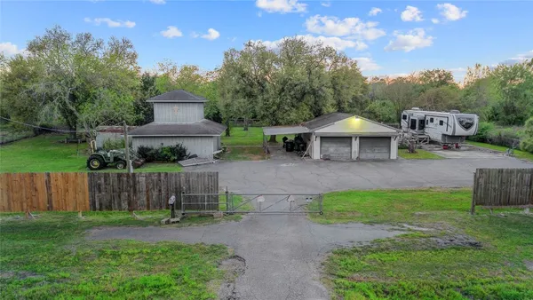 a view of a house with backyard and a sitting area