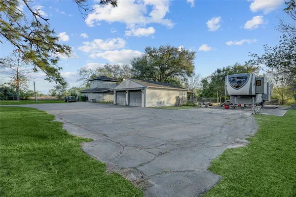 a view of house with outdoor space and garden