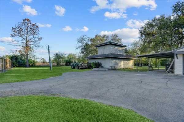 a view of a house with a yard and a patio