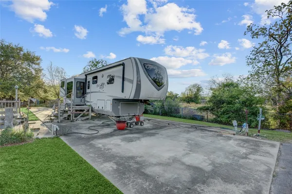 a view of a chair and table in backyard of the house