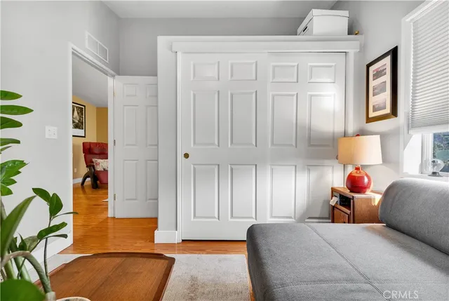 a bed room with a bed and a potted plant