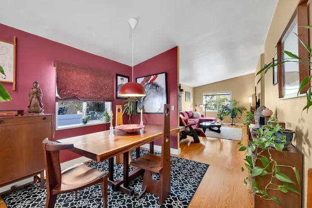 a living room with furniture a rug and a table