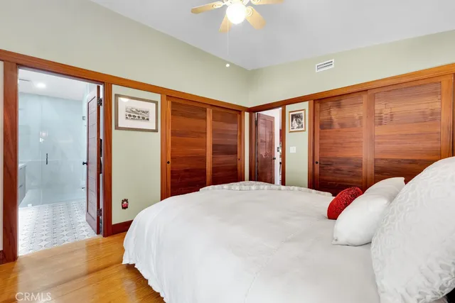 a bedroom with a large bed and a chandelier