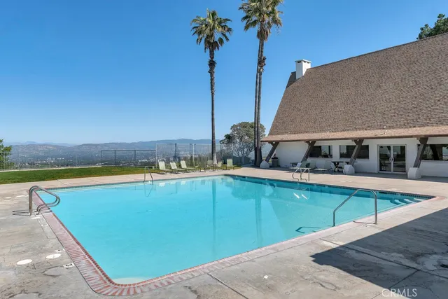 a view of a swimming pool with a lounge chair