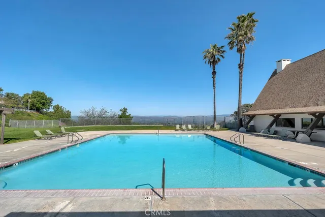 a view of a swimming pool with a lounge chair