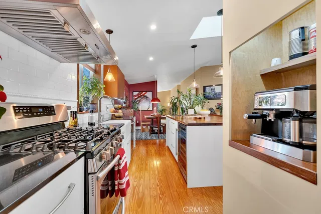 a kitchen with stainless steel appliances granite countertop a stove and a refrigerator