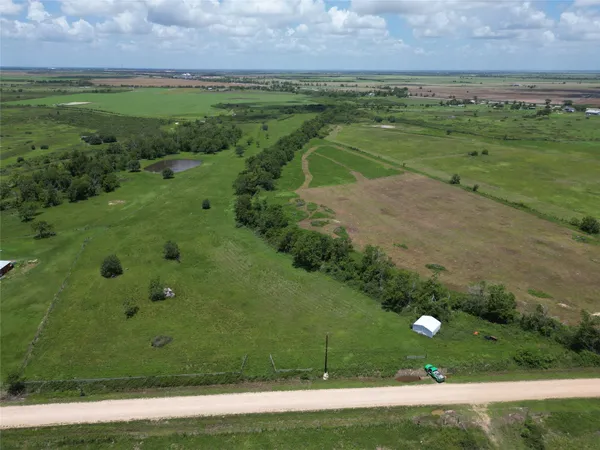 a view of a field with an trees