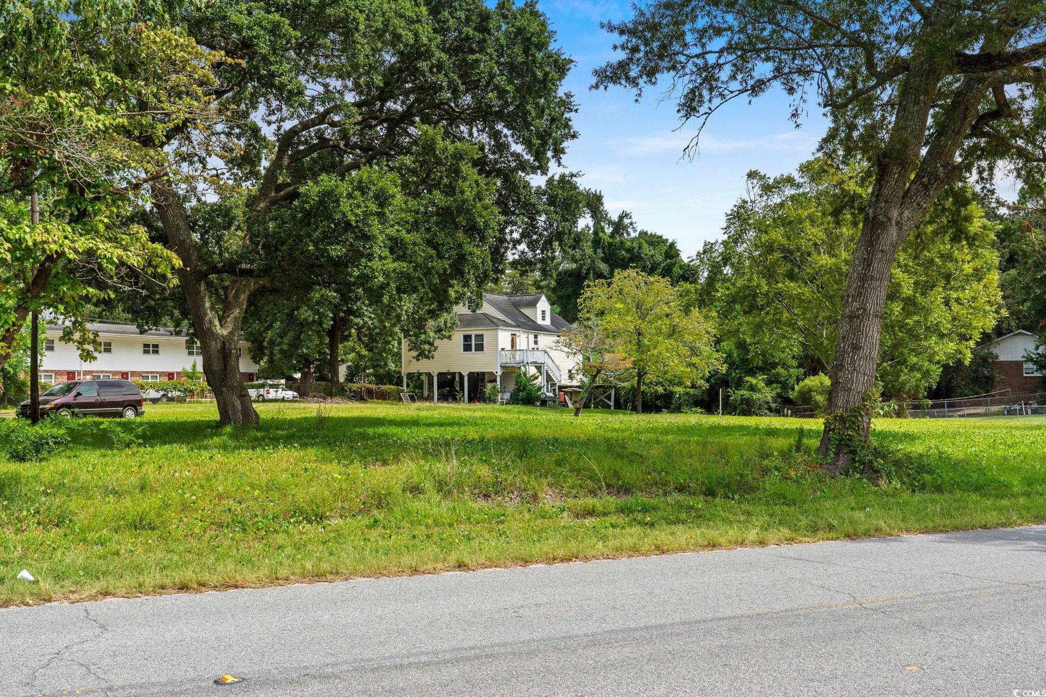 904 3rd Avenue North Myrtle Beach, SC 29577 - Photo 21 of 26 View of yard featuring view of wooded area