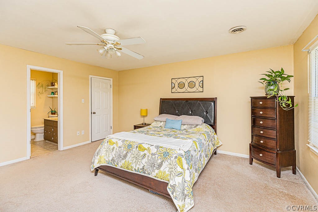 10801 Belvoir Road Chester, VA 23831 - Photo 12 of 23 a bedroom with a bed and a chandelier