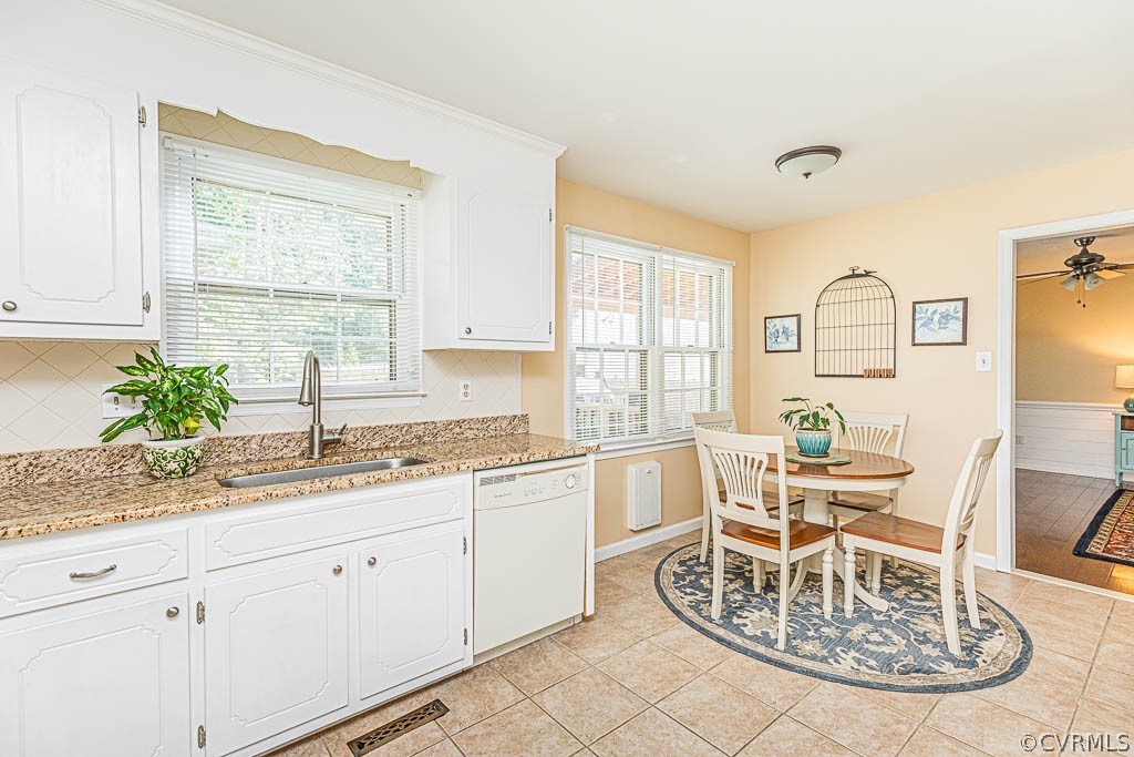 10801 Belvoir Road Chester, VA 23831 - Photo 8 of 23 a kitchen with a table chairs and white cabinets