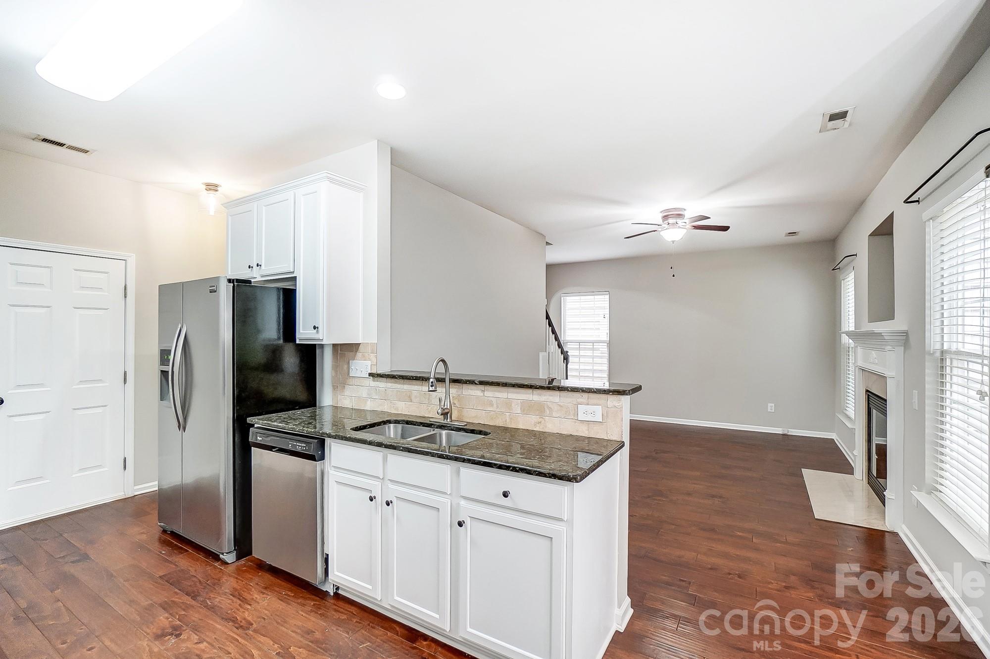 4914 Sunset Ridge Court Charlotte, NC 28269 - Photo 11 of 48 a kitchen with stainless steel appliances granite countertop a refrigerator and a sink