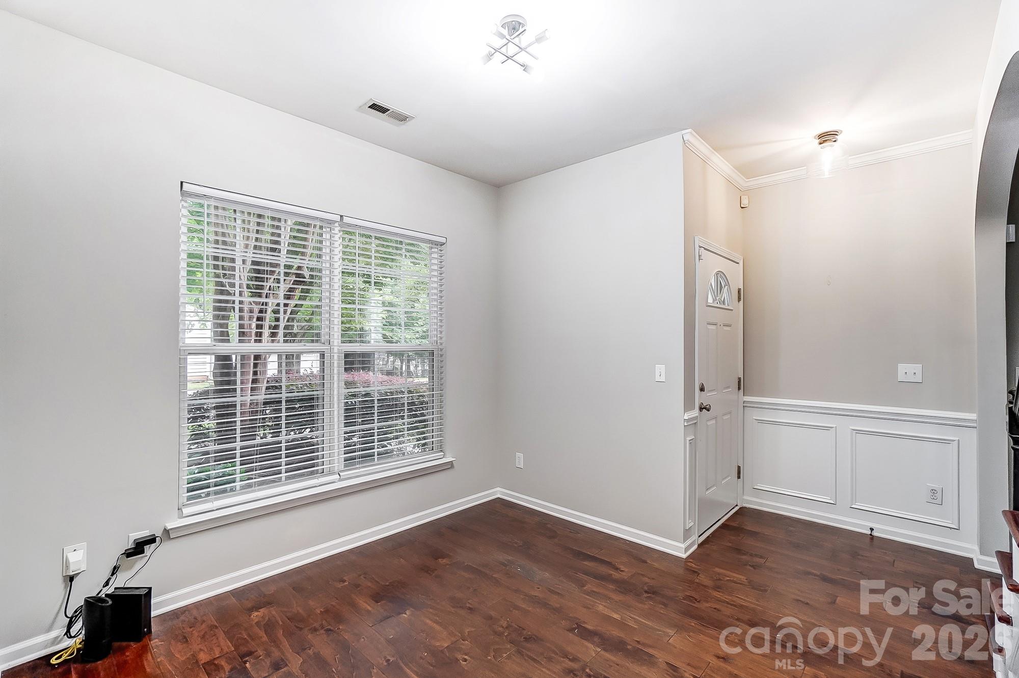 4914 Sunset Ridge Court Charlotte, NC 28269 - Photo 19 of 48 a view of an empty room with wooden floor and a window