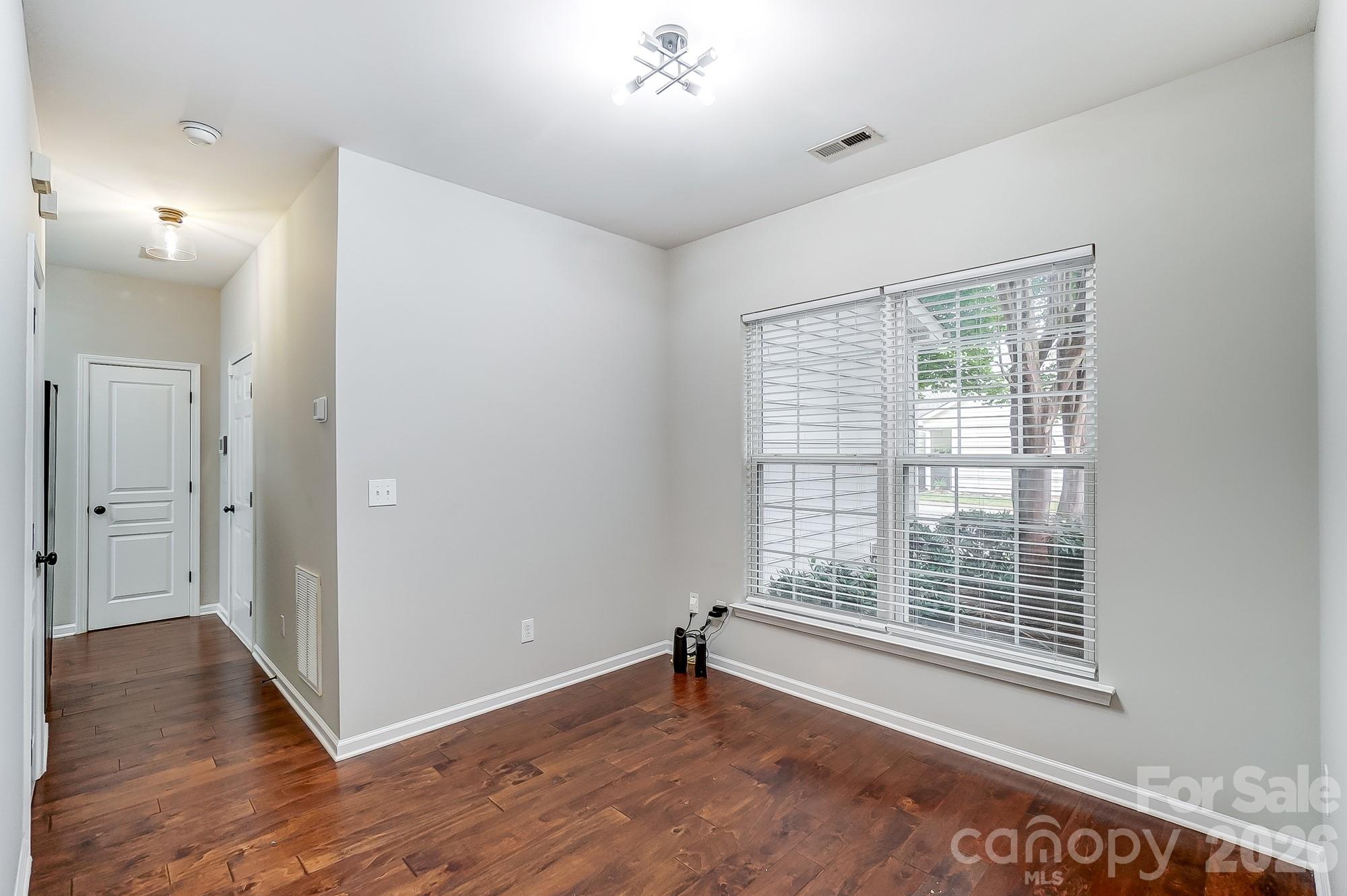 4914 Sunset Ridge Court Charlotte, NC 28269 - Photo 20 of 48 a view of an empty room with wooden floor and a window