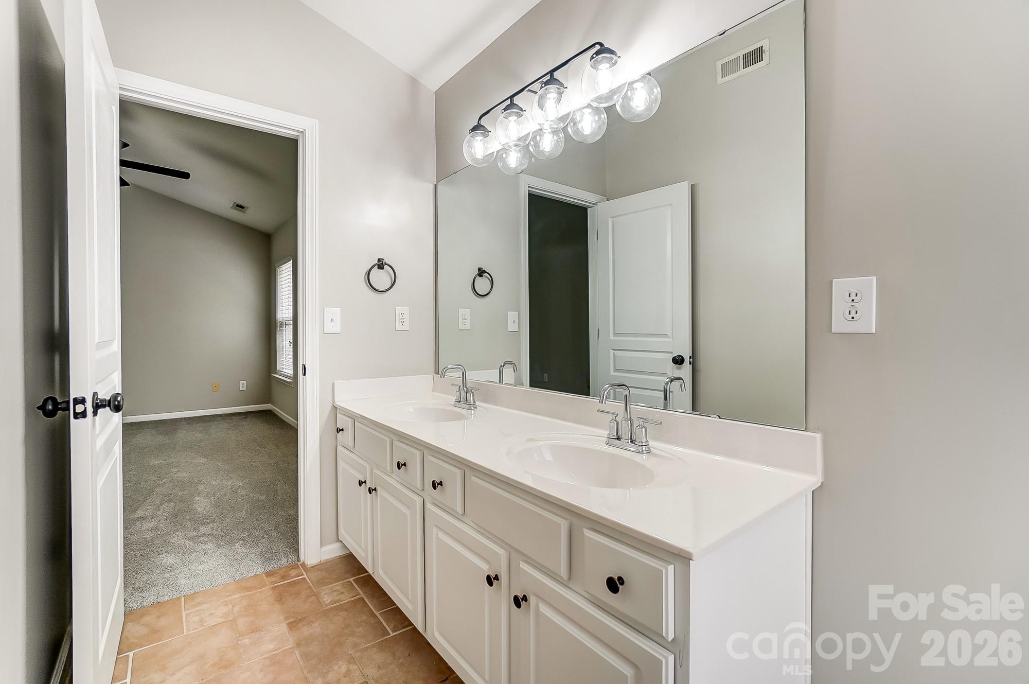 4914 Sunset Ridge Court Charlotte, NC 28269 - Photo 29 of 48 a bathroom with double vanity sink and a mirror
